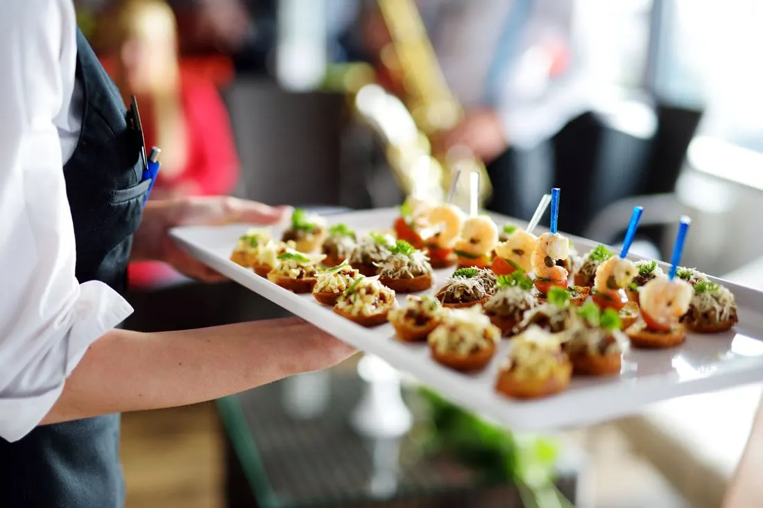 Server carrying a tray of hors d'oeuvres
